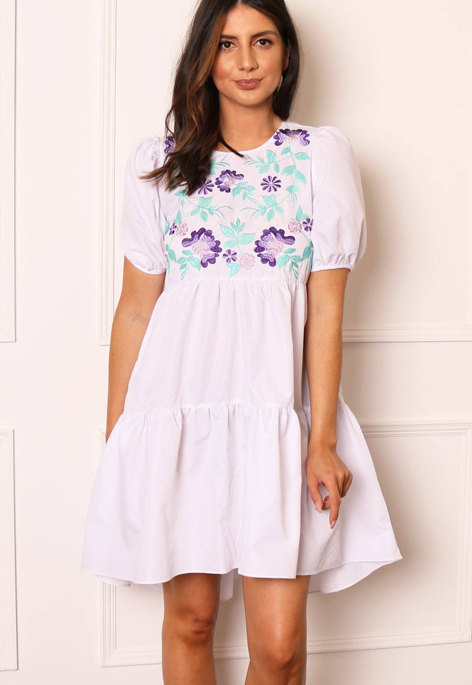 
                  
                    Voluminous Embroidered Tiered Dip Hem Mini Smock Dress with in White - One Nation Clothing
                  
                