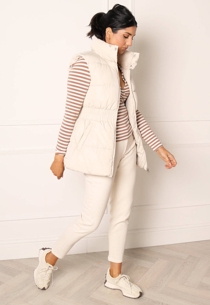 
                  
                    JDY Imagine Short Puffer Puffer Gilet with Waist Detail in Cream - One Nation Clothing
                  
                